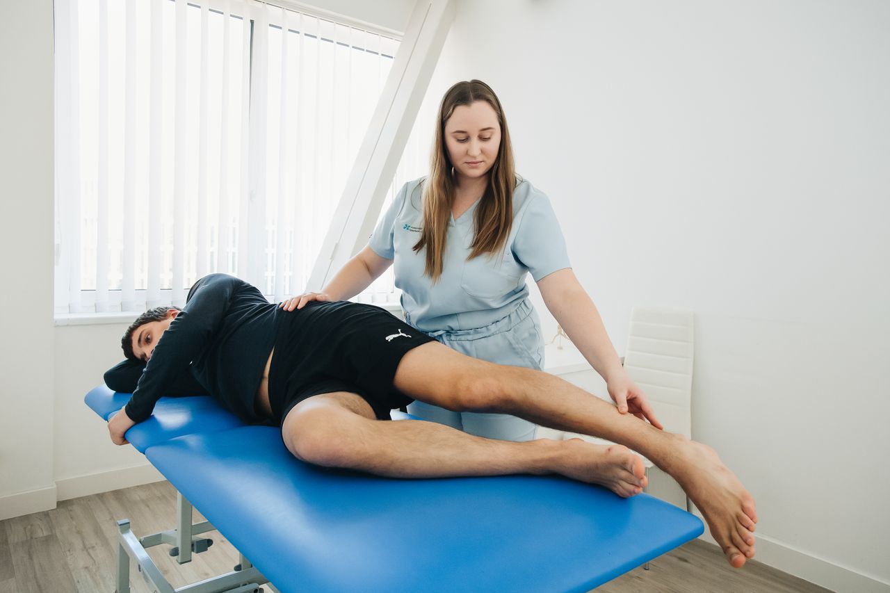 Home A physiotherapist assists a patient in a rehabilitation session at a Vilnius clinic.